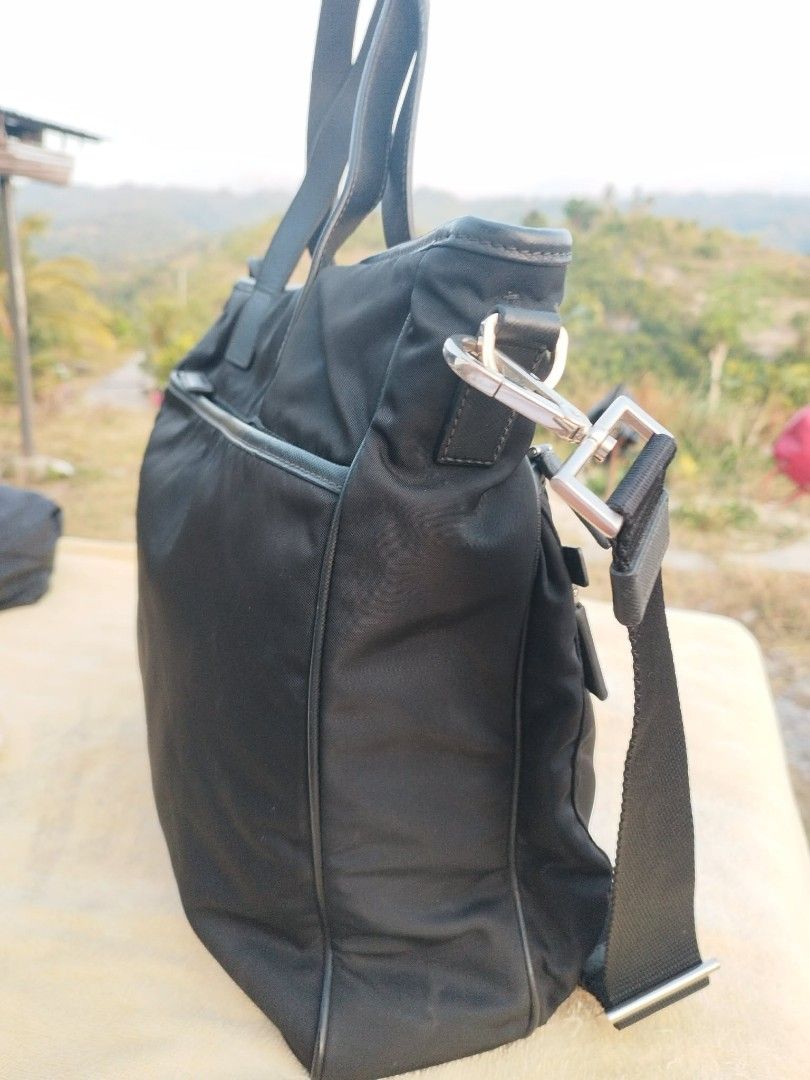 Prada Black Nylon Tote Bag (Category: Luxury Bags & Wallets) located in Cebu City. Submitted by tlisurplus (Listing ID 1431788947, Image 3). Description: - Authentic Prada tote bag - Includes a detachable shoulder strap - Features two front zip pockets - Main compartment with zipper closure - Interior Prada label - Silver-tone hardware - Top handles.