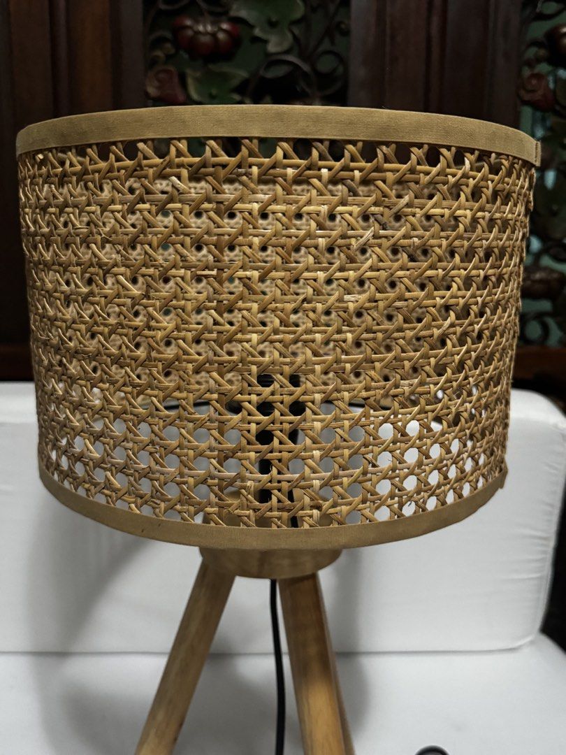 Rattan Shade Tripod Table Lamp (Category: Lighting) located in Quezon City. Submitted by limebasil (Listing ID 1431719909, Image 2). Description: - Woven rattan shade - Wooden tripod base - Neutral color - Provides ambient lighting - Standard electrical cord and socket - Adds natural texture Measurement: Height: 21 inches Diameter: 11.5inches.