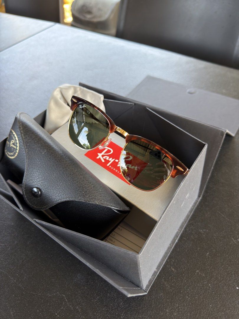Ray-Ban Clubmaster (Category: Sunglasses & Eyewear) located in Cebu City. Submitted by ehdstuff (Listing ID 1431598173, Image 1). Description: The Ray-Ban RB3016 Clubmaster Classic is an iconic 1950s-inspired sunglass model. Known for its bold browline design, it features a dark or contrasting acetate upper frame with a thin metal lower rim. This model is widely recognized for its retro-intellectual aesthetic and has been a staple in both film an