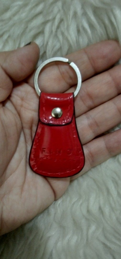 Red leather keychain (Category: Other Accessories) located in Quezon City. Submitted by eidorableshop (Listing ID 1431724195, Image 2). Description: - Vibrant red, glossy finish - Silver key ring - Secure snap closure - Unique, eye-catching shape - Made from durable material - A stylish key accessory.