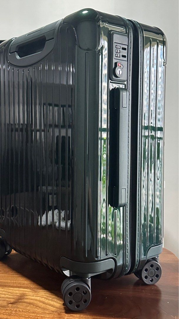 Rimowa Essential Cabin Suitcase - Green (Category: Luggage) located in Makati City. Submitted by bigboutique (Listing ID 1431778175, Image 2). Description: - Rimowa Essential Cabin suitcase - Dark Green - Secure locking mechanism - Smooth-rolling wheels - Organized interior with mesh dividers and packing straps - Includes protective dust bag and box (not in photo) - used once.