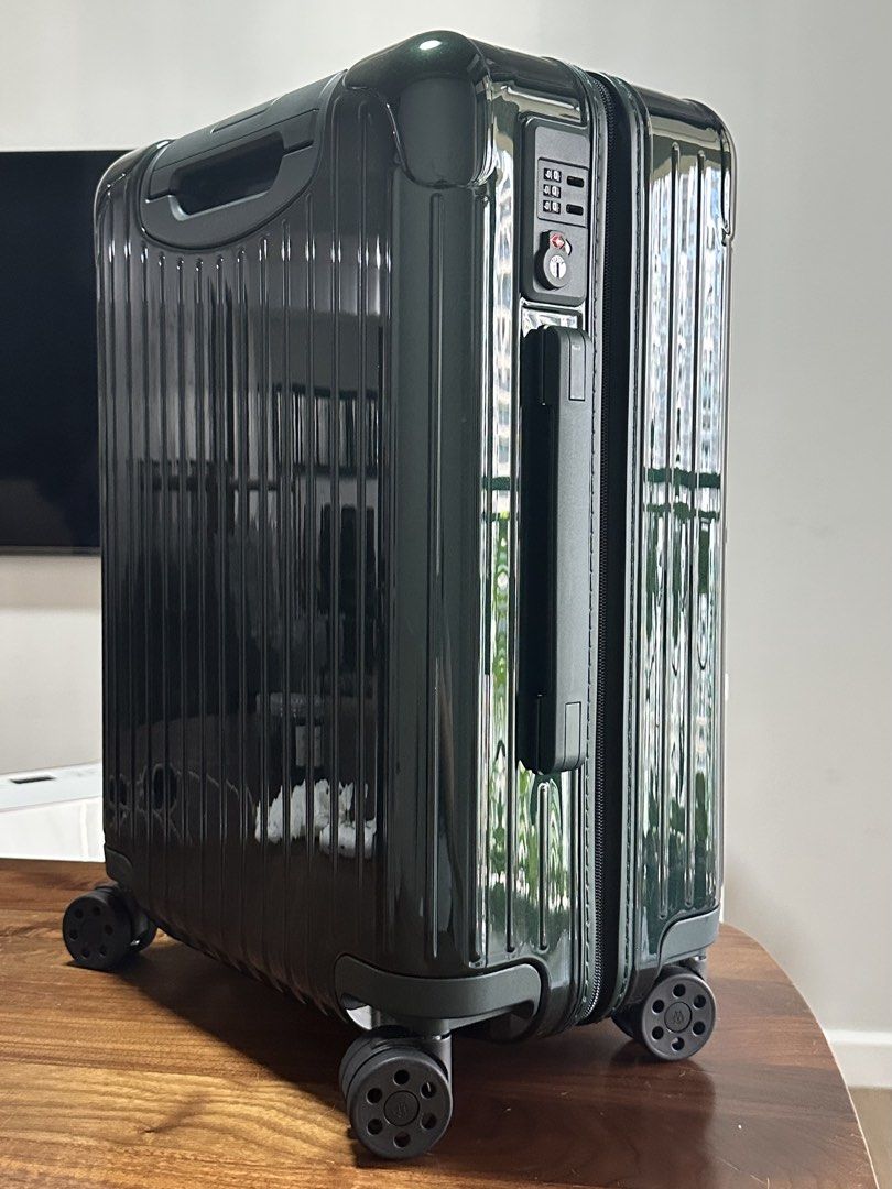 Rimowa Essential Cabin Suitcase - Green (Category: Luggage) located in Makati City. Submitted by bigboutique (Listing ID 1431778175, Image 3). Description: - Rimowa Essential Cabin suitcase - Dark Green - Secure locking mechanism - Smooth-rolling wheels - Organized interior with mesh dividers and packing straps - Includes protective dust bag and box (not in photo) - used once.