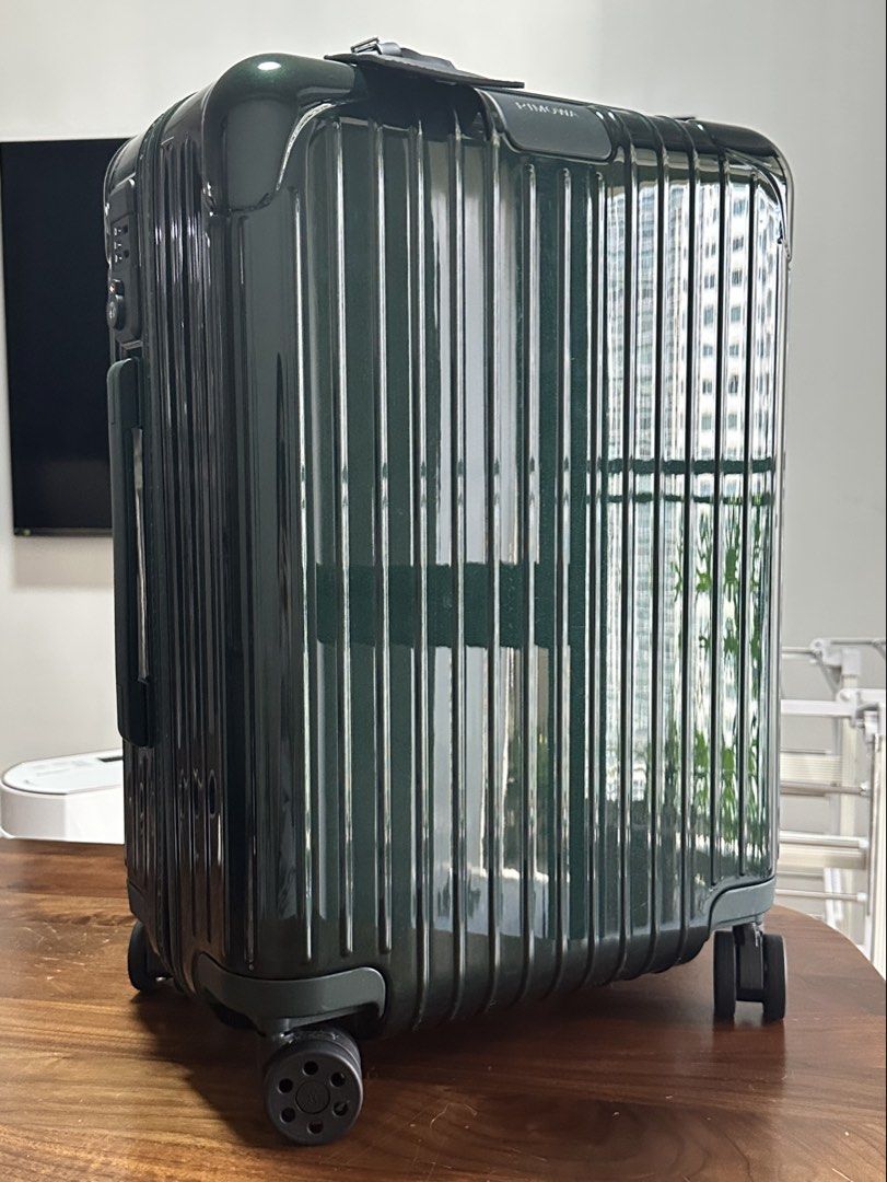 Rimowa Essential Cabin Suitcase - Green (Category: Luggage) located in Makati City. Submitted by bigboutique (Listing ID 1431778175, Image 1). Description: - Rimowa Essential Cabin suitcase - Dark Green - Secure locking mechanism - Smooth-rolling wheels - Organized interior with mesh dividers and packing straps - Includes protective dust bag and box (not in photo) - used once.