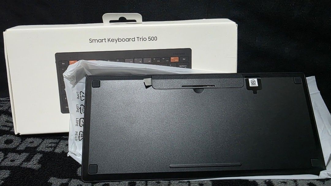 Samsung Smart Keyboard Trio 500 (Category: Computer Keyboard) located in Manila. Submitted by a.solo (Listing ID 1431638886, Image 3). Description: SAMSUNG SMART KEYBOARD TRIO 500 LET'S MAKE READING A HABIT ▪️Brand new and unused ▪️Compact design ▪️Stylish black color with orange accent keys ▪️Includes original box RFS: Decluttering Note: 1. Colors may vary slightly from the photo due to different lighting and screen displays. 2. For additional p