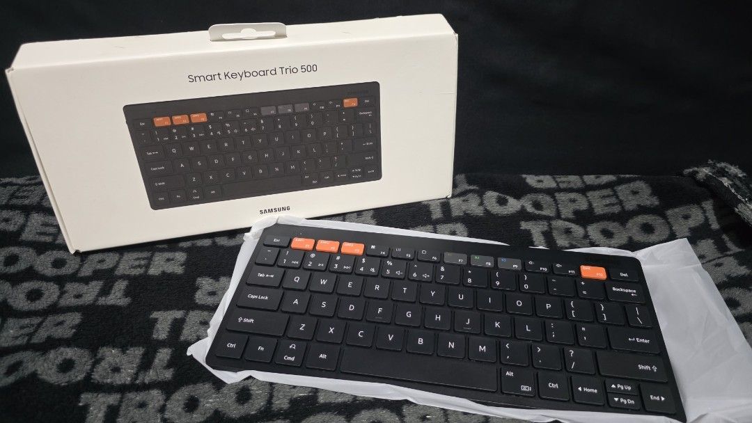 Samsung Smart Keyboard Trio 500 (Category: Computer Keyboard) located in Manila. Submitted by a.solo (Listing ID 1431638886, Image 2). Description: SAMSUNG SMART KEYBOARD TRIO 500 LET'S MAKE READING A HABIT ▪️Brand new and unused ▪️Compact design ▪️Stylish black color with orange accent keys ▪️Includes original box RFS: Decluttering Note: 1. Colors may vary slightly from the photo due to different lighting and screen displays. 2. For additional p