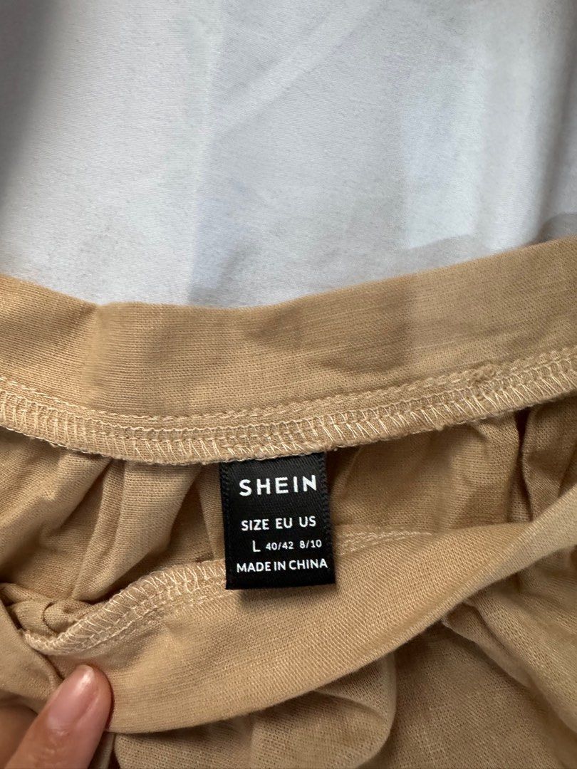 Shein Off-Shoulder Ruffle Top (Category: Blouses) located in Manila. Submitted by raphaelain17296 (Listing ID 1431734972, Image 3). Description: - Shein off-shoulder top - Beige color - Size: L - Design: Layered ruffles - Sleeves: Short - Origin: Made in China.