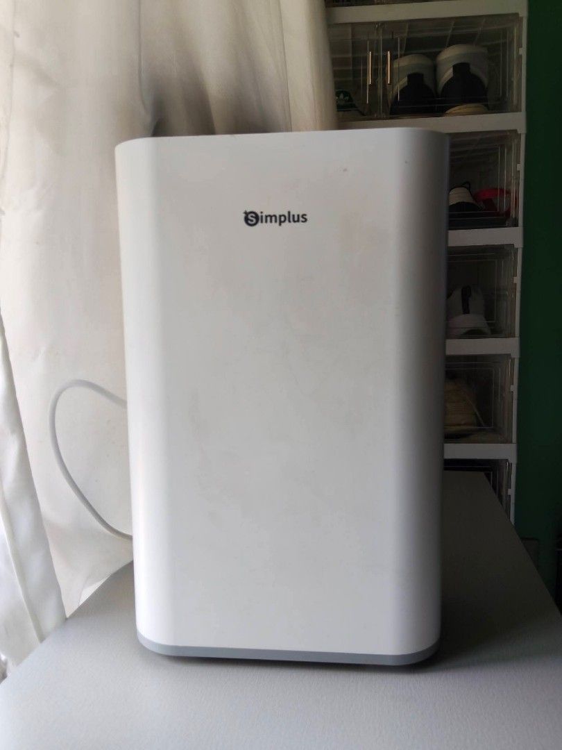 Simplus Dehumidifier (Category: Air Purifiers & Dehumidifiers) located in Pasig City. Submitted by comfort_sole (Listing ID 1431679094, Image 1). Description: - White Simplus air purifier - Rectangular design with rounded corners - Gray base - Simplus logo on front.