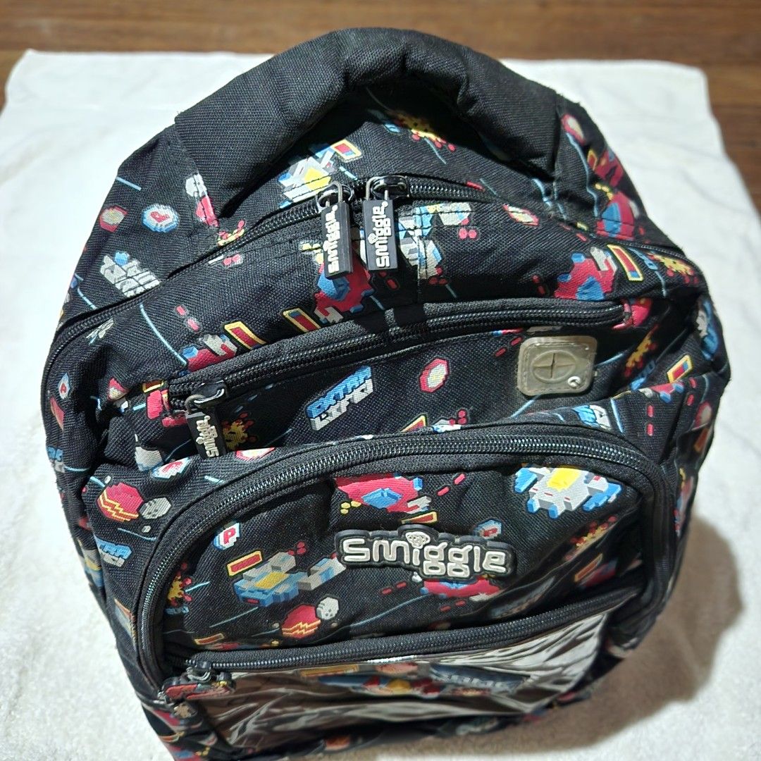 Smiggle Black Backpack (Category: Babies & Kids Fashion) located in Taguig. Submitted by sarisaristorebyks (Listing ID 1431760302, Image 3). Description: Original Flaws: Stains sa ilalim ng bag.