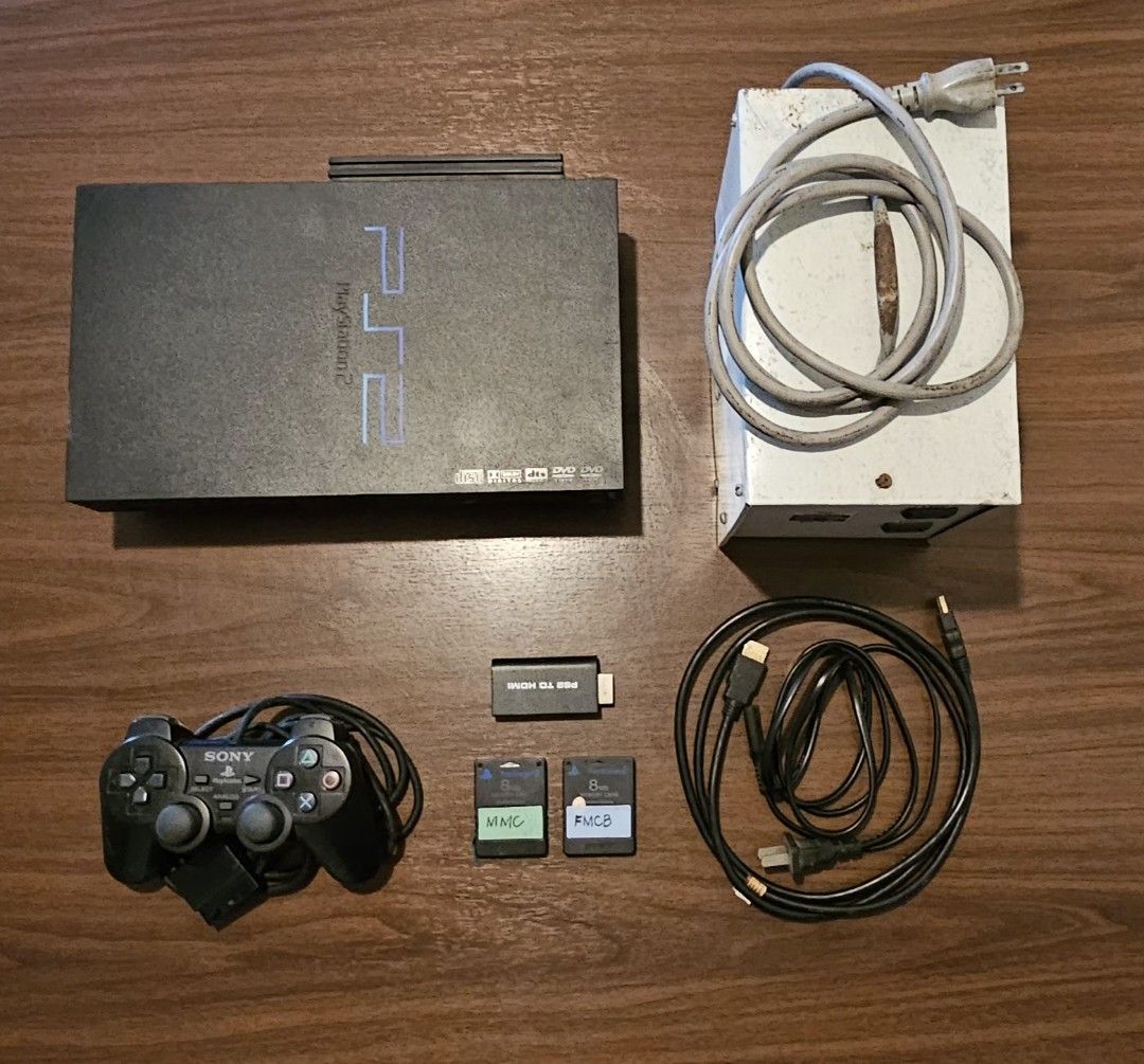 Sony PlayStation 2 Console (modified, 110v) (Category: PlayStation) located in Mandaluyong City. Submitted by limerick18 (Listing ID 1431631490, Image 3). Description: Selling 2nd hand modified PS2 console. Sold as-is. Inclusions: - Black PlayStation 2 console with 160GB HDD (Note: disc tray not working) -- FastHDBoot modified - 1 controller - AV Cable - PS2 to HDMI adapter (only works on some TV) - Memory Card - Transformer (110v) Power supply C