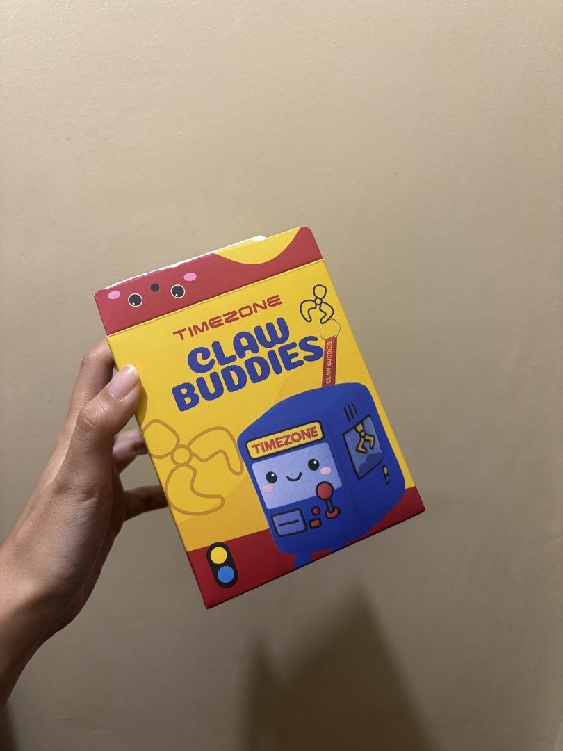Timezone Claw Buddies Winkie Plush Toy (Category: Plushies & Soft Toys) located in Manila. Submitted by prelovedbymarbz (Listing ID 1431683335, Image 2). Description: - Timezone Claw Buddies Winkie plush toy - Pink, cube-shaped character - Features a screen and legs - Brand new, in original packaging - Still sealed in plastic wrapping - Box includes Timezone Claw Buddies logo.