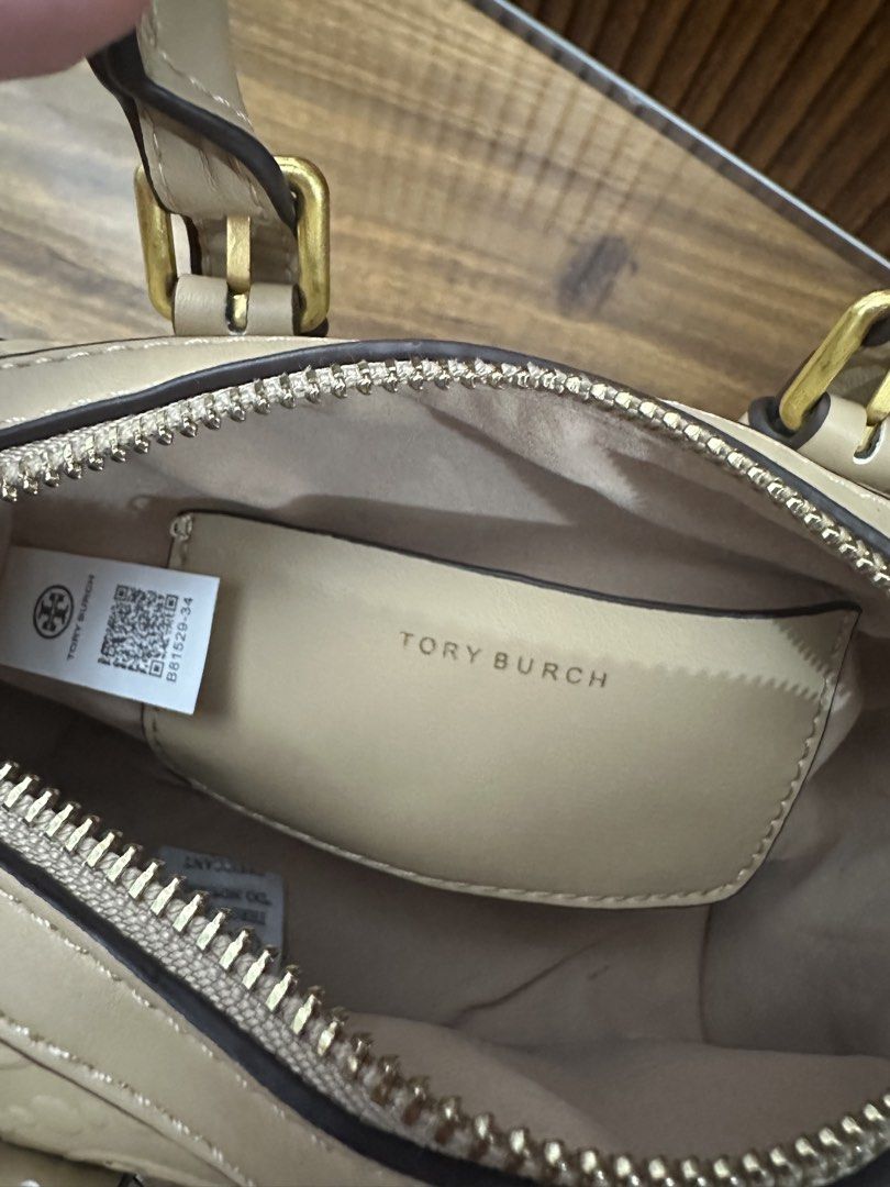 Tory Burch Embossed Satchel Bag (Category: Luxury Bags & Wallets) located in Batangas. Submitted by jhinp0t (Listing ID 1431621003, Image 2). Description: Mirror copy only pero napakaganda prestine condition - Tory Burch satchel bag - Embossed pattern - Top handle - Detachable shoulder strap - Small interior pocket with Tory Burch logo - Gold-tone hardware - Zip closure - Protective feet at the bottom.