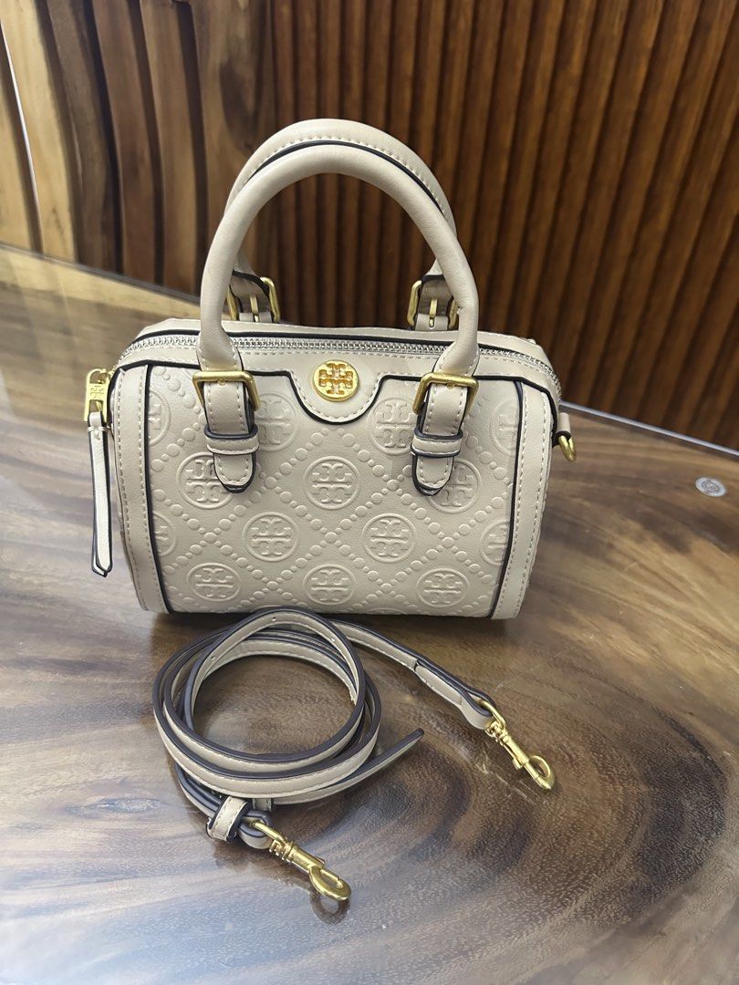 Tory Burch Embossed Satchel Bag (Category: Luxury Bags & Wallets) located in Batangas. Submitted by jhinp0t (Listing ID 1431621003, Image 1). Description: Mirror copy only pero napakaganda prestine condition - Tory Burch satchel bag - Embossed pattern - Top handle - Detachable shoulder strap - Small interior pocket with Tory Burch logo - Gold-tone hardware - Zip closure - Protective feet at the bottom.