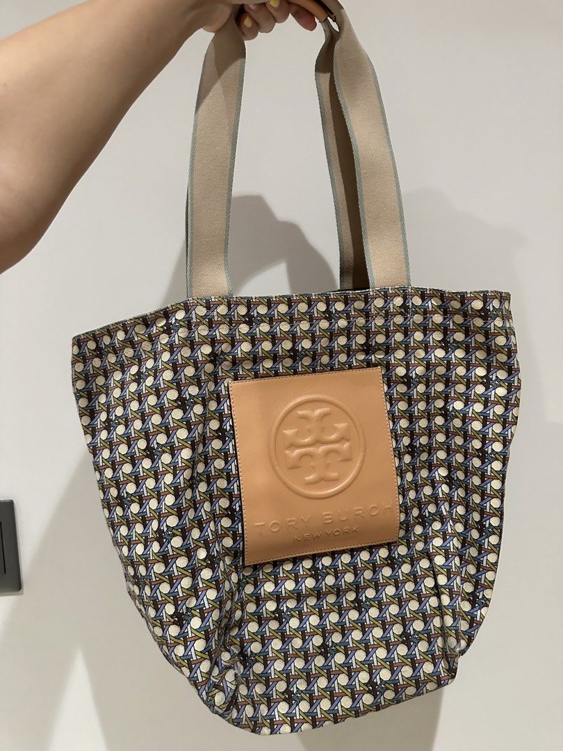 Tory Burch Gracie Tote Bag (Category: Luxury Bags & Wallets) located in Quezon City. Submitted by adc2011 (Listing ID 1431750993, Image 2). Description: - Tory Burch tote bag - Woven design - Leather logo patch - Spacious interior - Sturdy straps - Ideal for everyday or travel - Chic and functional Only issue is the discoloration at the bottom i placed bleach :( but not noticable when yo’re wearing it.