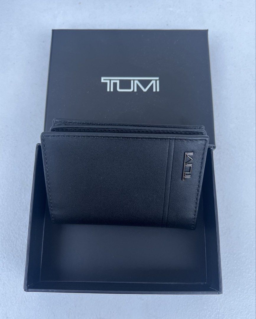 TUMI Leather Wallet / Card holder (Category: Wallets & Card Holders) located in Quezon City. Submitted by soohthings (Listing ID 1431576810, Image 1). Description: - TUMI leather wallet / card holder - Features multiple card slots - Includes a clear ID window - Comes with the original box - Classic black color - Original ; directly bought in Tumi store in US.