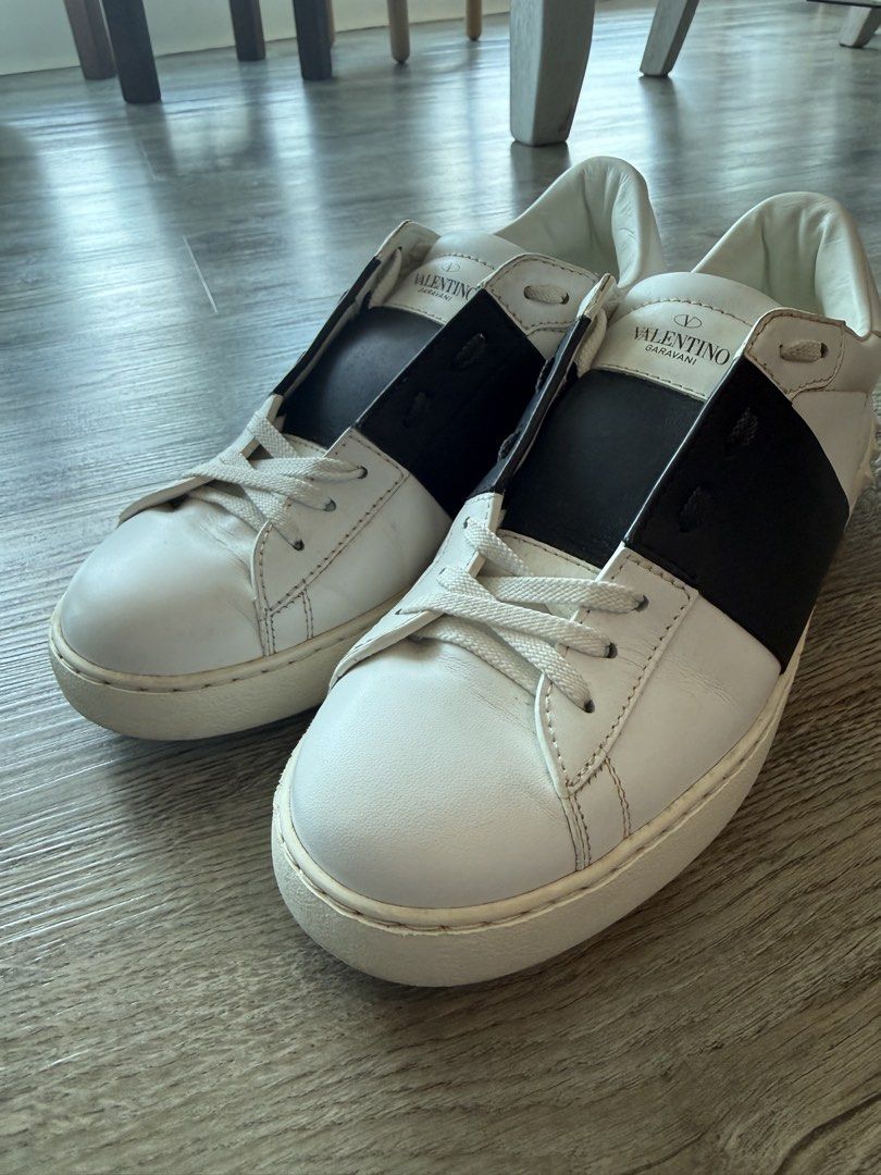Valentino Garavani White Sneakers (Category: Sneakers) located in Taguig. Submitted by hubert_go (Listing ID 1431584862, Image 1). Description: - Authentic Valentino Garavani sneakers - White with black accents - Valentino logo on tongue - Includes extra shoelaces - Size 42 - Made in Italy - Soles show wear - Visible wear and tear.
