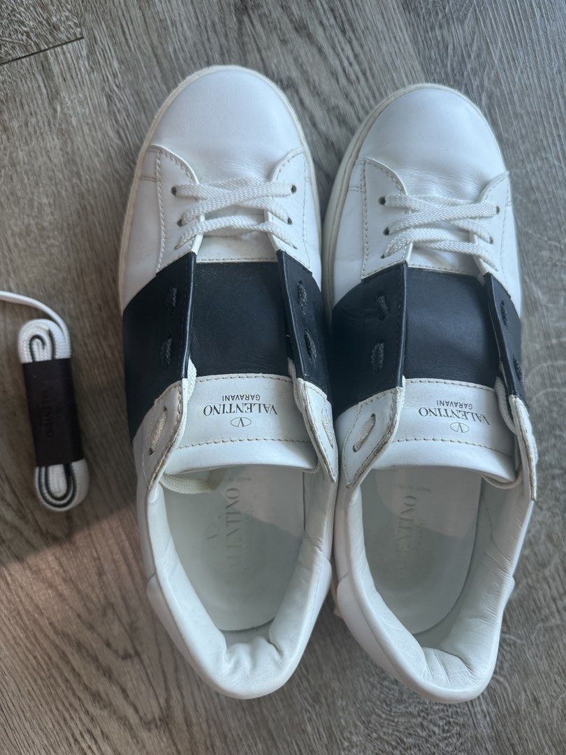 Valentino Garavani White Sneakers (Category: Sneakers) located in Taguig. Submitted by hubert_go (Listing ID 1431584862, Image 2). Description: - Authentic Valentino Garavani sneakers - White with black accents - Valentino logo on tongue - Includes extra shoelaces - Size 42 - Made in Italy - Soles show wear - Visible wear and tear.
