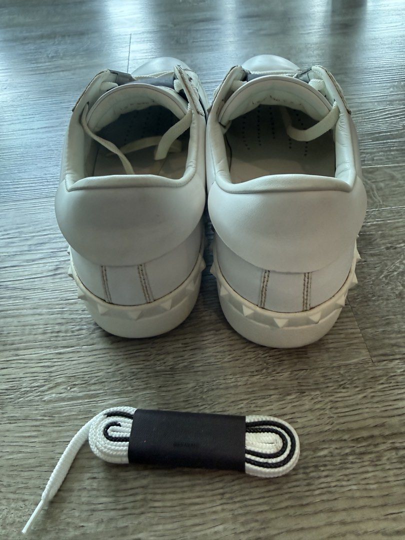 Valentino Garavani White Sneakers (Category: Sneakers) located in Taguig. Submitted by hubert_go (Listing ID 1431584862, Image 3). Description: - Authentic Valentino Garavani sneakers - White with black accents - Valentino logo on tongue - Includes extra shoelaces - Size 42 - Made in Italy - Soles show wear - Visible wear and tear.