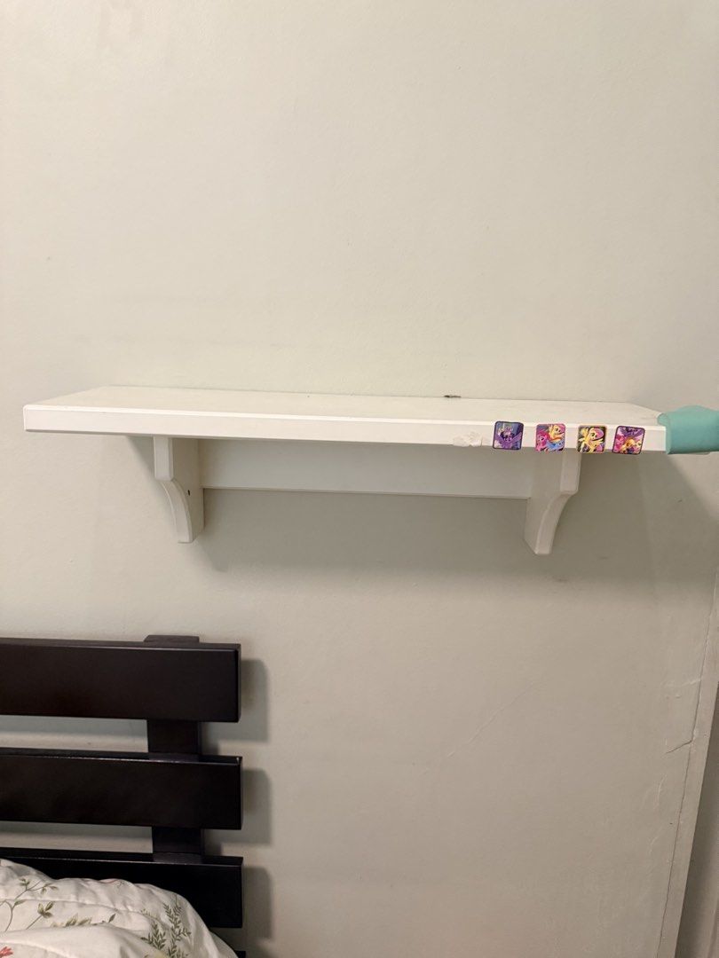 Pottery Barn White Wall Shelf (Category: Shelves, Cabinets & Racks) located in Pasig City. Submitted by mbbproperties (Listing ID 1431638180, Image 1). Description: - White wooden wall shelf - Includes two brackets for mounting - Rectangular shape - Simple design - Features stickers on the front edge - Ideal for displaying small items or storage - Made of wood.