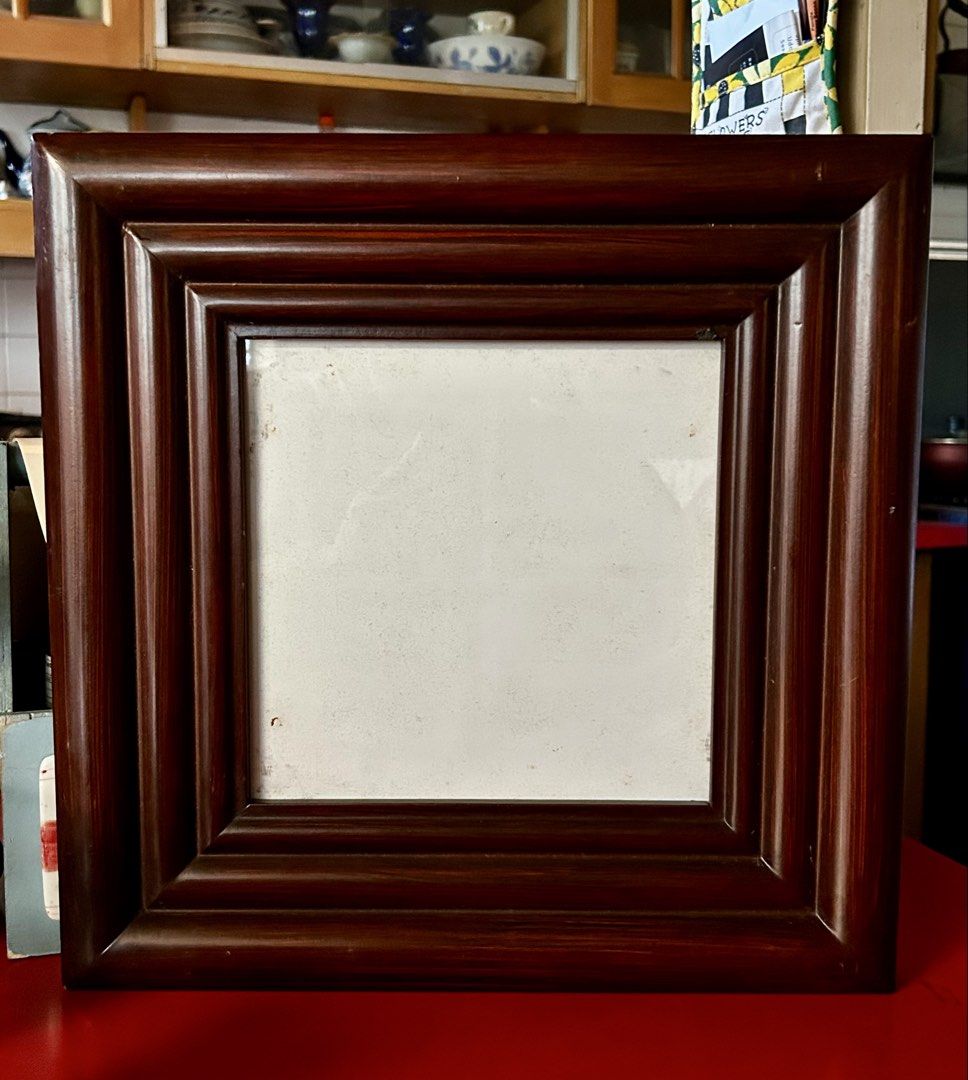 Wooden Photo Frame (Category: Frames & Pictures) located in Las Pinas. Submitted by rjmwings (Listing ID 1431592424, Image 1). Description: Square wooden photo frame with a dark brown finish. 14” x 14” It has a layered design around the opening. The back has metal clips to hold the photo in place and two hooks for hanging. The frame is ready to display your favorite photos..