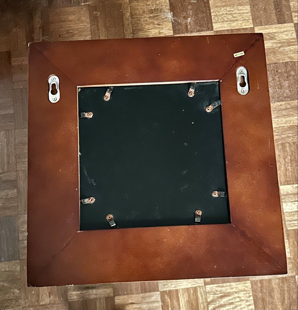 Wooden Photo Frame (Category: Frames & Pictures) located in Las Pinas. Submitted by rjmwings (Listing ID 1431592424, Image 2). Description: Square wooden photo frame with a dark brown finish. 14” x 14” It has a layered design around the opening. The back has metal clips to hold the photo in place and two hooks for hanging. The frame is ready to display your favorite photos..