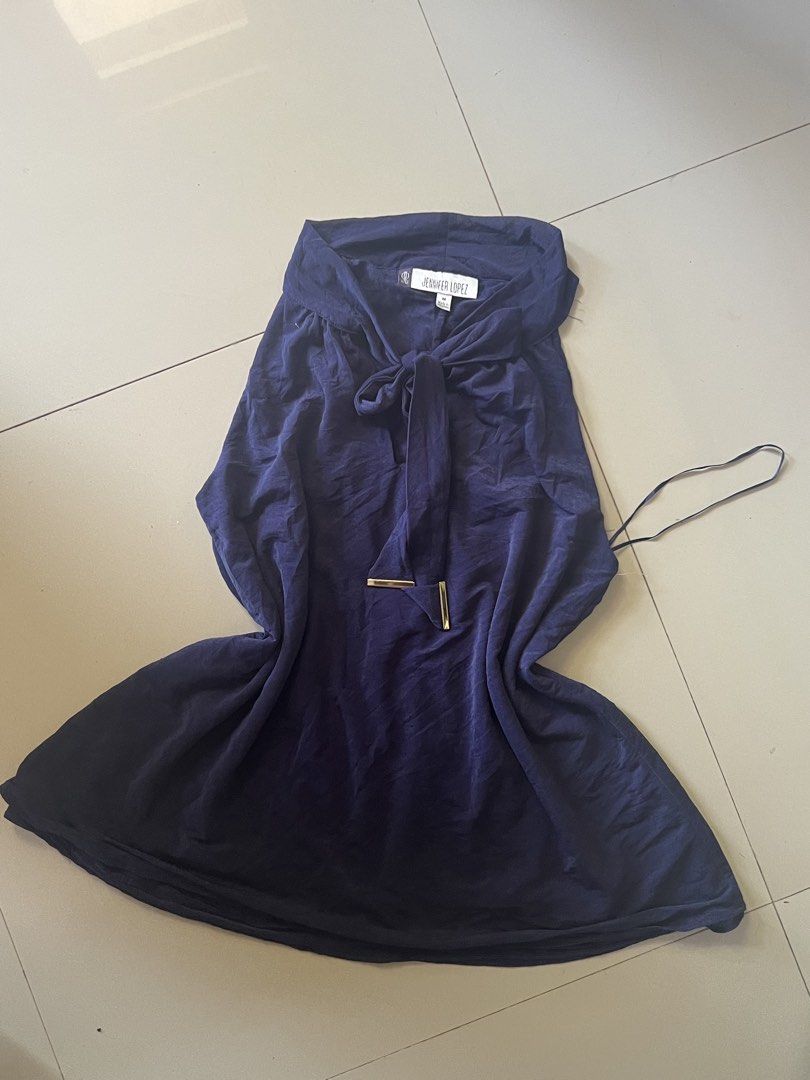 Y2k halter top Jennifer Lopez Navy Top (Category: Sleeveless) located in Manila. Submitted by alingmads (Listing ID 1431641567, Image 1). Description: - Jennifer Lopez navy top - Size: Medium - Features a tie detail at the front - Gold-colored accent - Made in the Philippines - Slight sheen fabric - Unique design - Versatile addition to your wardrobe.