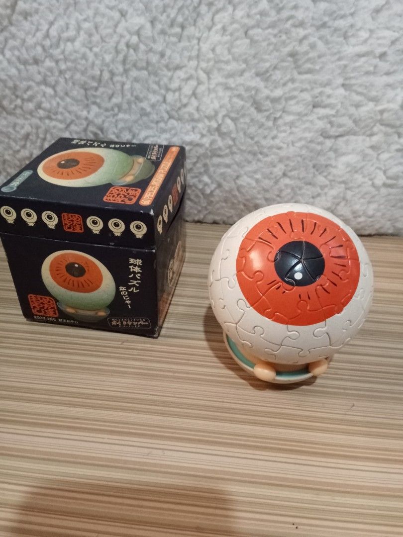 Yanoman 3D Eye Ball Jigsaw Puzzle (Category: Board Games & Puzzles) located in Bocaue. Submitted by marajapansurplus (Listing ID 1431601102, Image 1). Description: - 3D Eye Ball Jigsaw Puzzle - Brand: Yanoman - 60 pieces - Features an eye shape with an orange iris and black pupil - Comes with the original box - Box has Japanese text.