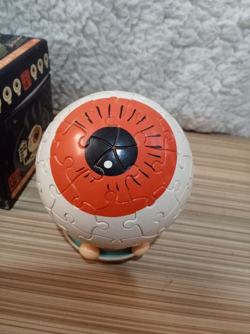 Yanoman 3D Eye Ball Jigsaw Puzzle (Category: Board Games & Puzzles) located in Bocaue. Submitted by marajapansurplus (Listing ID 1431601102, Image 3). Description: - 3D Eye Ball Jigsaw Puzzle - Brand: Yanoman - 60 pieces - Features an eye shape with an orange iris and black pupil - Comes with the original box - Box has Japanese text.