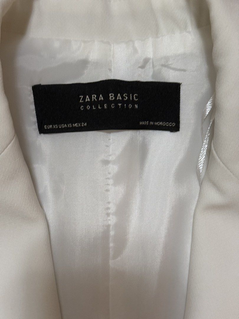 Zara Basic Collection Vest (Category: Sleeveless) located in Quezon City. Submitted by declutter1ngmama (Listing ID 1431588066, Image 2). Description: - Zara Basic white vest - Double-breasted design - Features four buttons - Two front pockets - Size: XS - Made in Morocco - small stain on the right side - blazer length 29 inches .