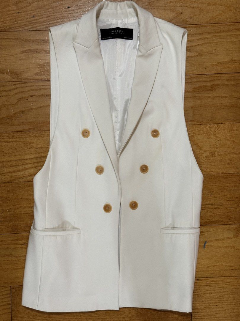 Zara Basic Collection Vest (Category: Sleeveless) located in Quezon City. Submitted by declutter1ngmama (Listing ID 1431588066, Image 1). Description: - Zara Basic white vest - Double-breasted design - Features four buttons - Two front pockets - Size: XS - Made in Morocco - small stain on the right side - blazer length 29 inches .