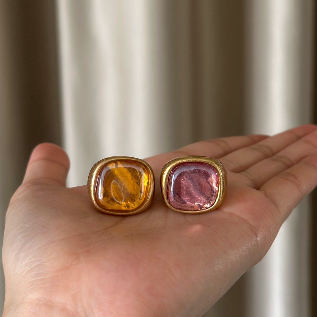Zara Gold Statement Ring Set (2 pcs, Amber & Pink Stone) (Category: Rings) located in Taguig. Submitted by camiladeclutters (Listing ID 1431745232, Image 1). Description: Worn only once for an event, in great condition overall. Please refer to the photos for details. Features: – Chunky gold-toned band – Amber/yellow stone + pink stone – Statement / vintage-inspired with a playful, artsy vibe – Lightweight and comfy to wear Size: Zara size S (appr