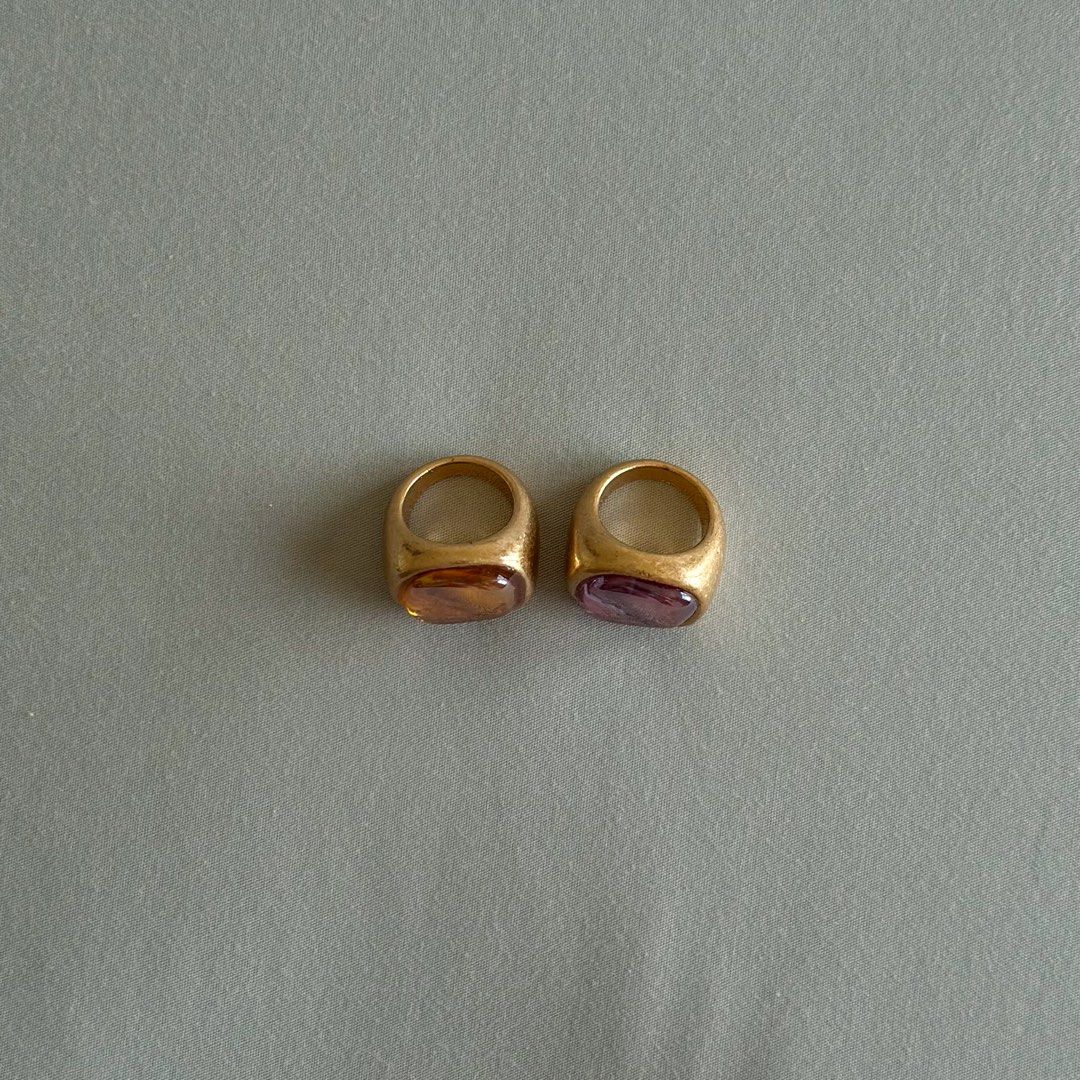 Zara Gold Statement Ring Set (2 pcs, Amber & Pink Stone) (Category: Rings) located in Taguig. Submitted by camiladeclutters (Listing ID 1431745232, Image 2). Description: Worn only once for an event, in great condition overall. Please refer to the photos for details. Features: – Chunky gold-toned band – Amber/yellow stone + pink stone – Statement / vintage-inspired with a playful, artsy vibe – Lightweight and comfy to wear Size: Zara size S (appr