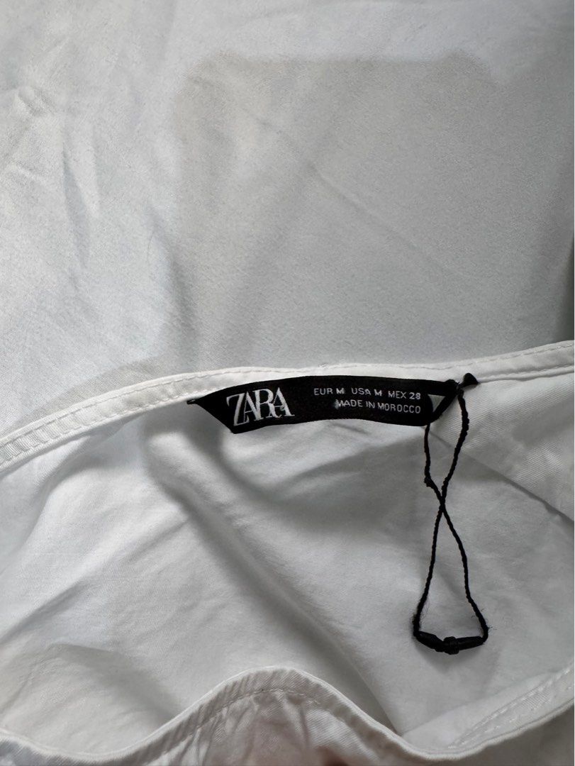 Zara White Shirt - Size M (Category: Shirts) located in Manila. Submitted by raphaelain17296 (Listing ID 1431734714, Image 3). Description: - Zara white shirt - Button-down style - Long sleeves - Features drawstring detail - Size: M - Made in Morocco.
