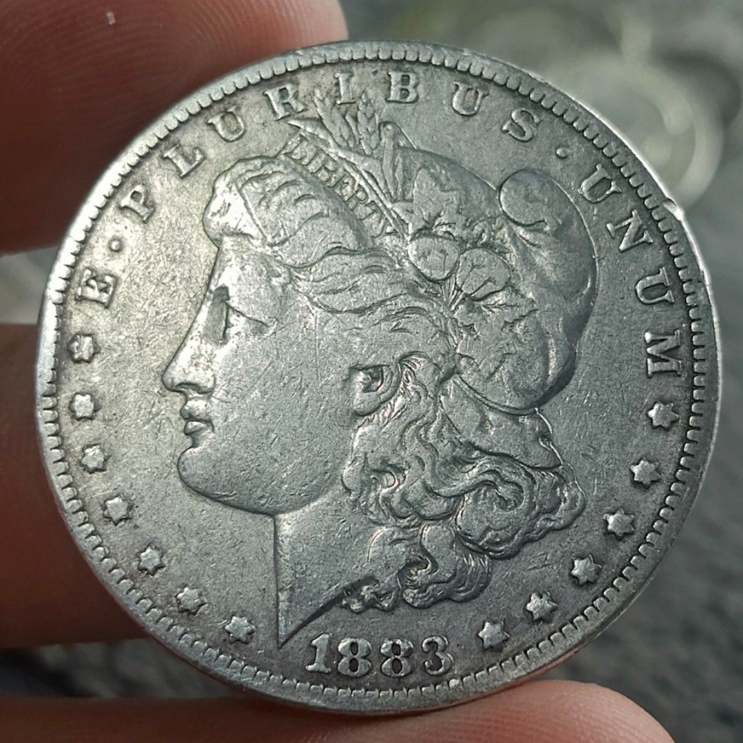 1883 Morgan Silver Dollar Coin (Category: Currency) located in Quezon City. Submitted by Coiners (Listing ID 1431994264, Image 1). Description: - 1883 Silver Dollar Coin - Obverse: Lady Liberty, "E PLURIBUS UNUM", and 1883 date - Reverse: Eagle, "UNITED STATES OF AMERICA", and "ONE DOLLAR" - A classic US collectible coin..