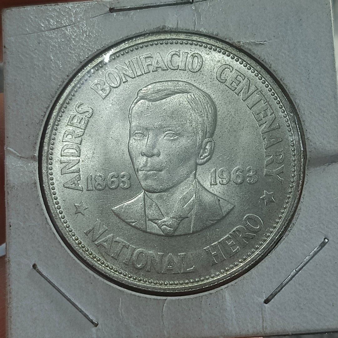 1963 Andres Bonifacio Centenary One Peso Coin (Category: Currency) located in Quezon City. Submitted by Coiners (Listing ID 1431994077, Image 1). Description: - 1963 One Peso coin - Commemorates Andres Bonifacio's centenary - Features Andres Bonifacio on the front - Central Bank of the Philippines seal on the back - Comes with a protective holder - Ideal for coin collectors.