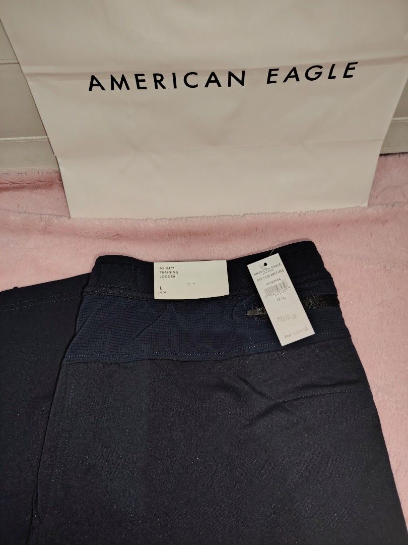 American Eagle Men's Pants (Category: Jeans) located in Taguig. Submitted by rtk06 (Listing ID 1431958417, Image 2). Description: American Eagle men's pants. One pair is navy blue with a drawstring and the other is olive green with a belt. Both pairs have tags attached. The navy blue pair has a size L tag. The olive green pair has a size XL. Item comes with paper bag. Feel free to message me for more info. .