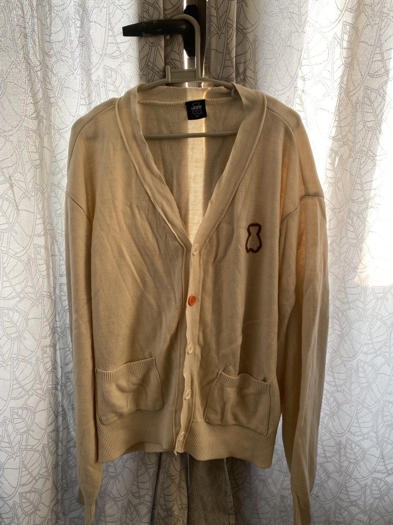 AQO Studio Space Cream Cardigan (Category: Coats, Jackets and Outerwear) located in Manila. Submitted by lomlberries (Listing ID 1431893580, Image 1). Description: - Cream-colored cardigan from AQO Studio Space - Features a bear logo on the chest - Two front pockets - Button-up closure with an orange button - Size: F - Condition: Good.