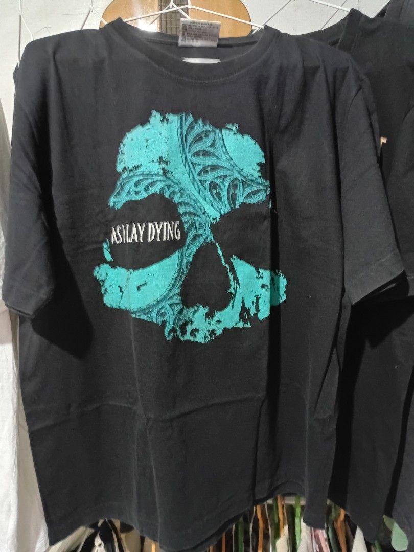 As I Lay Dying Black T-Shirt (Category: Tshirts & Polo Shirts ) located in Quezon City. Submitted by reddcluttermnl (Listing ID 1431885165, Image 1). Description: - Black As I Lay Dying t-shirt - Band name printed on the back - Features a turquoise design on the front - Made of a cotton blend - Large on tag.