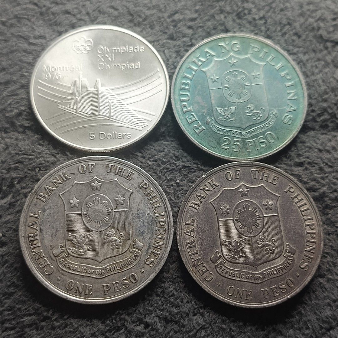 Assorted Silver Commemorative Coins (Category: Currency) located in Quezon City. Submitted by Coiners (Listing ID 1431994108, Image 2). Description: - Commemorative coin collection. - Includes: - 1976 Canada coin - 1974 Philippine coin - Two 1964 Apolinario Mabini Centenary coins - 1976 Montreal Olympics coin - Two Philippine One Peso coins - Features various designs and inscriptions. - Showcases historical figures and events. - Ideal for coin co