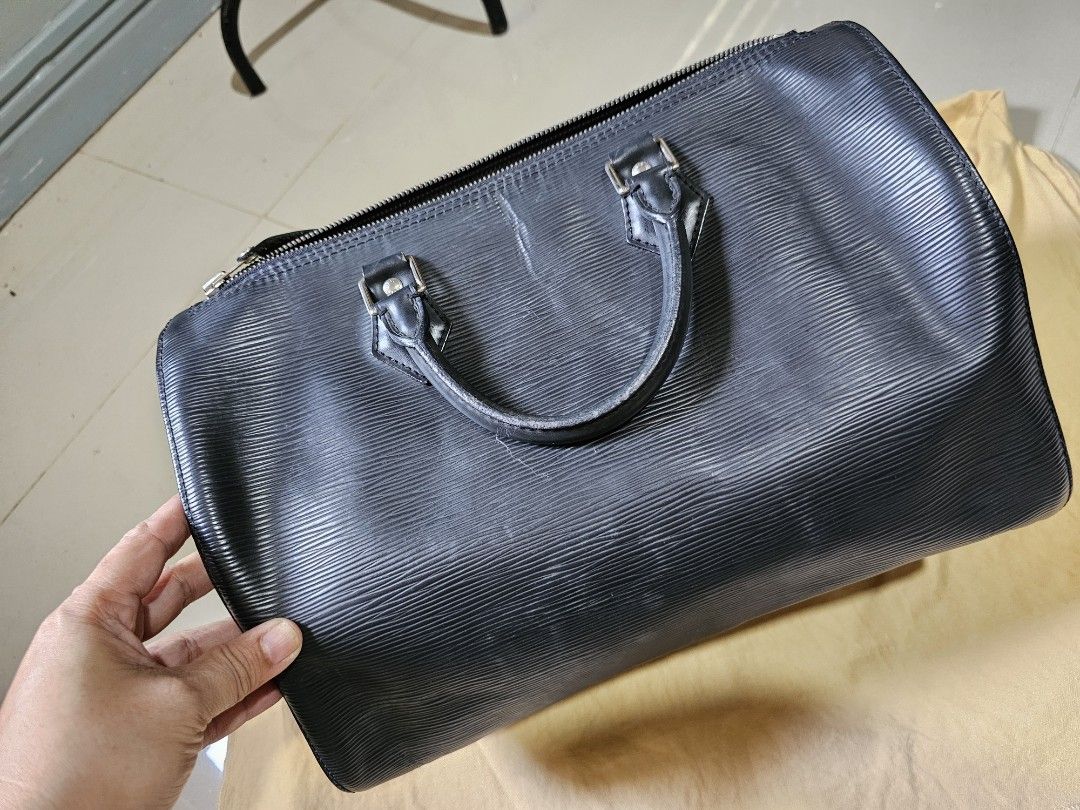 AUTH LV Epi Speedy 30 Black (Category: Luxury Bags & Wallets) located in Cagayan de Oro. Submitted by hotpink26 (Listing ID 1431819104, Image 2). Description: - Authentic Louis Vuitton Epi Speedy 30 - Black Epi leather exterior - Zip closure - Rolled leather handles - Spacious interior - Includes padlock and keys - Fabric-lined interior with slip pocket - Made in France.