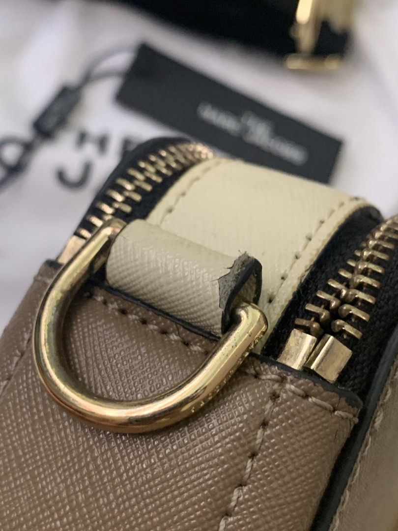 Authentic Marc Jacobs Snapshot Camera Bag (Category: Luxury Bags & Wallets) located in Manila. Submitted by ilovepreloved.thine (Listing ID 1431839360, Image 3). Description: - Authentic Marc Jacobs Snapshot camera bag - Gold-tone 'J' logo and hardware - Detachable and adjustable logo strap - Dual-compartment design with zip closure - Includes dust bag, tags, and wrist strap - Black interior lining - Made in Vietnam - Conditon: 9/10 just signs of