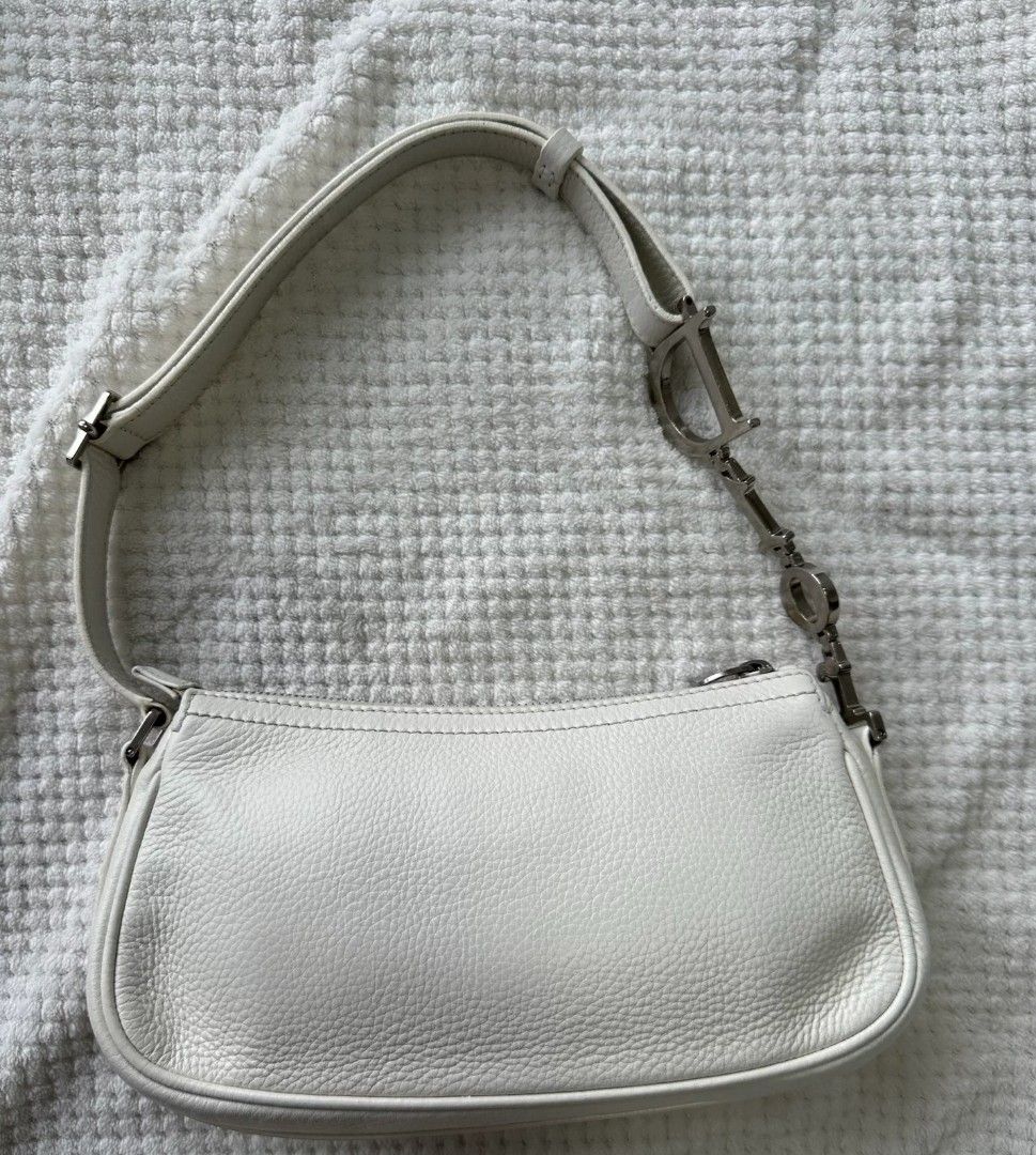 Authentic Rare Dior Spell out D-charm Pochette in White (Category: Luxury Bags & Wallets) located in Quezon City. Submitted by rarefindsgirlie (Listing ID 1431889095, Image 3). Description: all photos/details posted already 🚫MARKET PRICE NOW: ranges starts from 33K-45K (depends on condition) ps: 1st pic for thumbnail only, the rest are my actuals. White pebbled leather with incredible Dior silver plaque detailing and large “D” charm. Spacious an