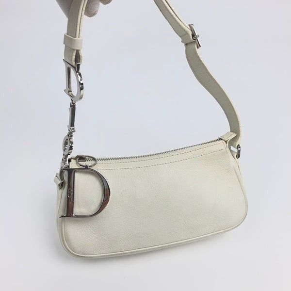 Authentic Rare Dior Spell out D-charm Pochette in White (Category: Luxury Bags & Wallets) located in Quezon City. Submitted by rarefindsgirlie (Listing ID 1431889095, Image 1). Description: all photos/details posted already 🚫MARKET PRICE NOW: ranges starts from 33K-45K (depends on condition) ps: 1st pic for thumbnail only, the rest are my actuals. White pebbled leather with incredible Dior silver plaque detailing and large “D” charm. Spacious an