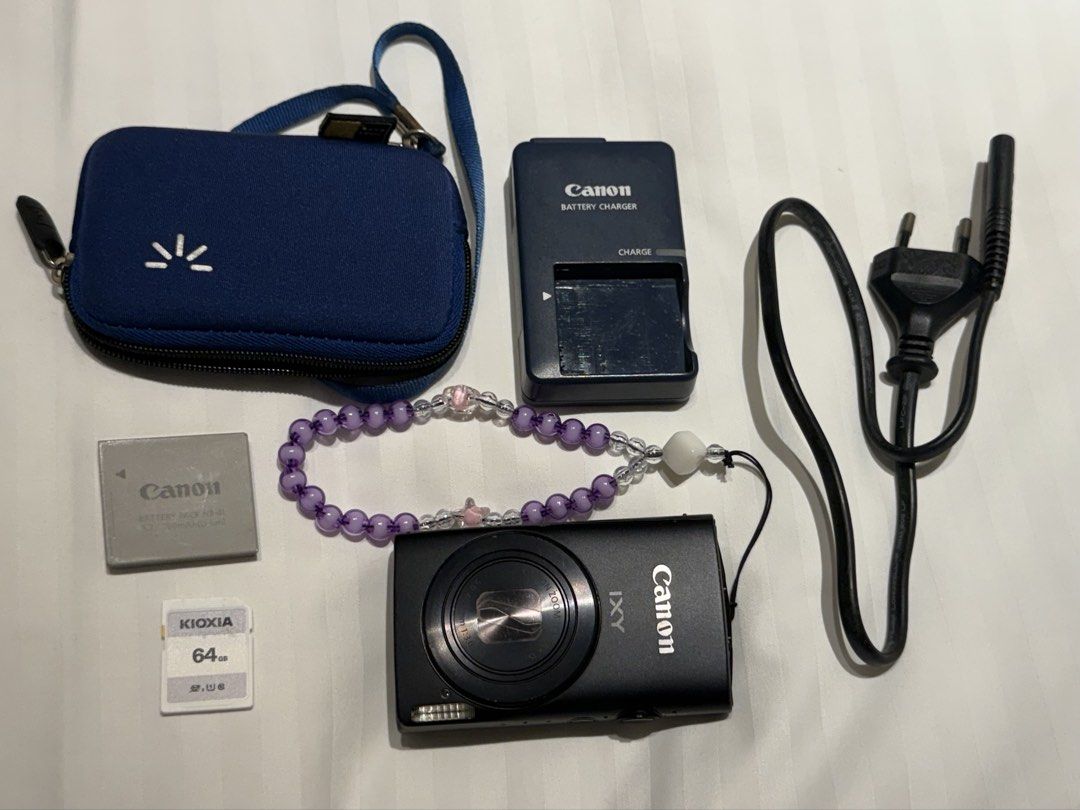Canon IXY 600F Full HD Digital Camera (Category: Cameras) located in Silang. Submitted by retrotechhh (Listing ID 1431858967, Image 1). Description: - Canon IXY 600F digital camera (black) - Includes charger and battery - 64GB SD card included - Comes with a carrying case - Features an on/off button .