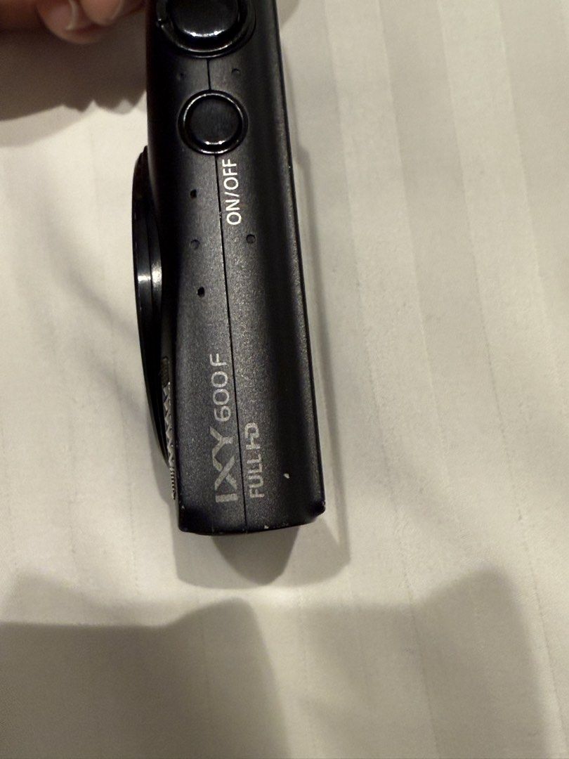 Canon IXY 600F Full HD Digital Camera (Category: Cameras) located in Silang. Submitted by retrotechhh (Listing ID 1431858967, Image 2). Description: - Canon IXY 600F digital camera (black) - Includes charger and battery - 64GB SD card included - Comes with a carrying case - Features an on/off button .