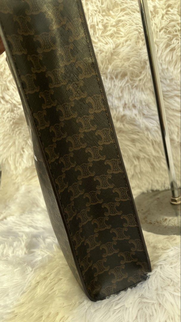Celine Vertical Cabas Tote Bag (Category: Luxury Bags & Wallets) located in Muntinlupa City. Submitted by armendaber03743 (Listing ID 1431900546, Image 3). Description: Celine Vertical Cabas tote bag in brown. Features a brown leather handle and a detachable strap. The bag has a zipper closure and an interior pocket. The exterior features the Celine logo and pattern. The interior lining is a light brown color..