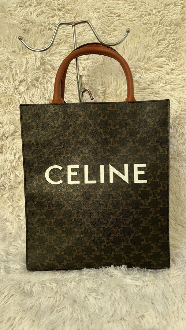 Celine Vertical Cabas Tote Bag (Category: Luxury Bags & Wallets) located in Muntinlupa City. Submitted by armendaber03743 (Listing ID 1431900546, Image 1). Description: Celine Vertical Cabas tote bag in brown. Features a brown leather handle and a detachable strap. The bag has a zipper closure and an interior pocket. The exterior features the Celine logo and pattern. The interior lining is a light brown color..