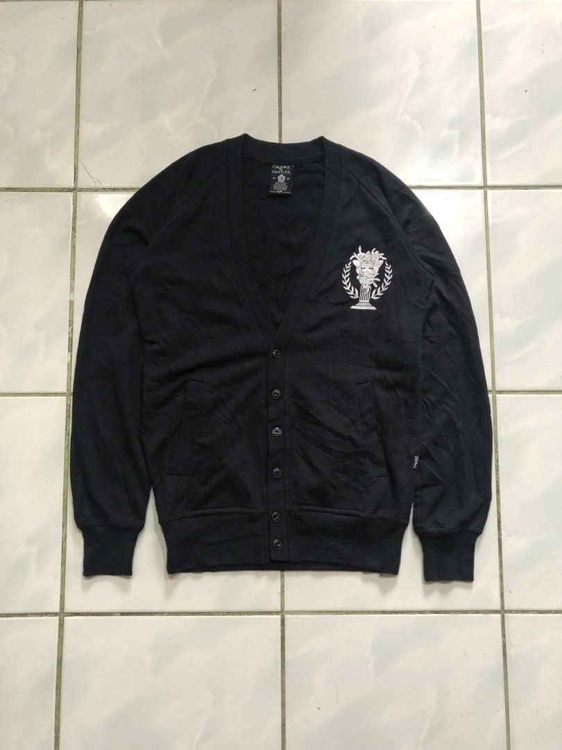 Crooks & Castles Black Cardigan (Category: Coats, Jackets and Outerwear) located in Sipalay. Submitted by lptulak (Listing ID 1431945178, Image 2). Description: - Crooks & Castles cardigan - Black color - Button-down front - V-neck design - Brand logo on chest and back - Long sleeves - Ribbed cuffs - Soft fabric - Size tag visible.