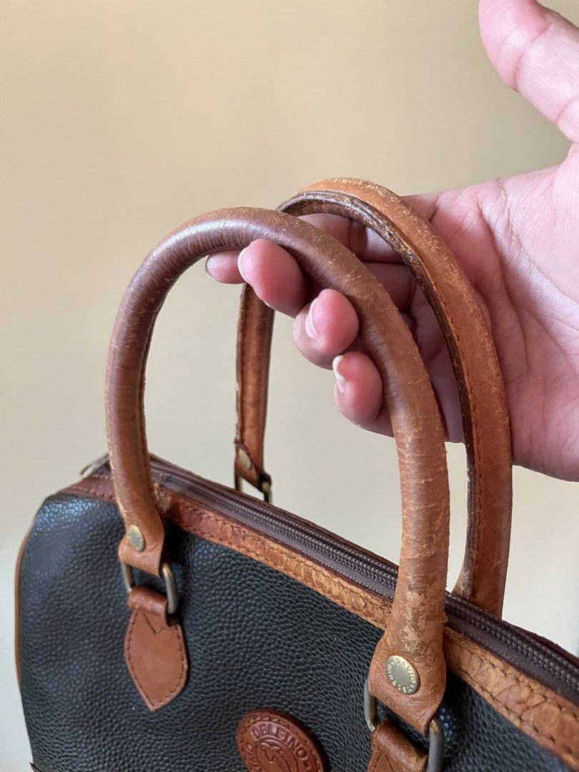 DELFINO DOCTORS BAG (Category: Luxury Bags & Wallets) located in Mandaluyong City. Submitted by chmrxx (Listing ID 1431852920, Image 2). Description: - Vintage Delfino handbag - Black textured body - Brown leather accents - Top zipper closure - Dual top handles - Interior zippered pocket - Shows wear on handles and corners.