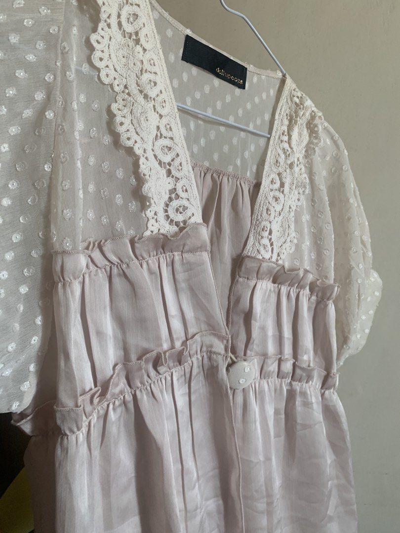 dollupoops beige pink lace and polka dot whimsy top (Category: Blouses) located in Pasay City. Submitted by nicnacks (Listing ID 1431873711, Image 2). Description: - Dollupoops blouse - Delicate lace neckline - Polka dot sleeves - Light pink ruffled bodice - V-neck design - Button closure - Flowy, lightweight fabric - Perfect for a feminine look.