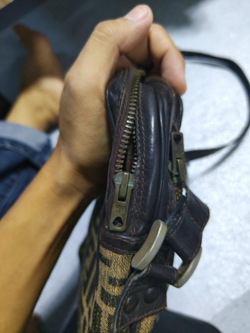 Fendi FF Logo Shoulder Bag (Category: Luxury Bags & Wallets) located in Davao. Submitted by navil01 (Listing ID 1431874899, Image 3). Description: - Authentic Fendi shoulder bag - Features the iconic FF logo pattern - Brown leather strap and trim - Interior includes a small pocket - Made in Italy.